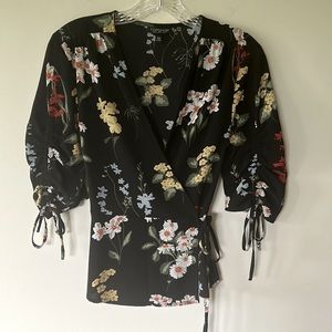 Topshop wrap blouse in black floral with detail sleeves. Size 2 EUC